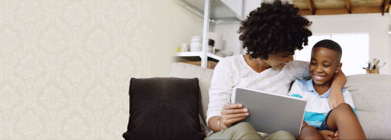 parent with child playing games on tablet